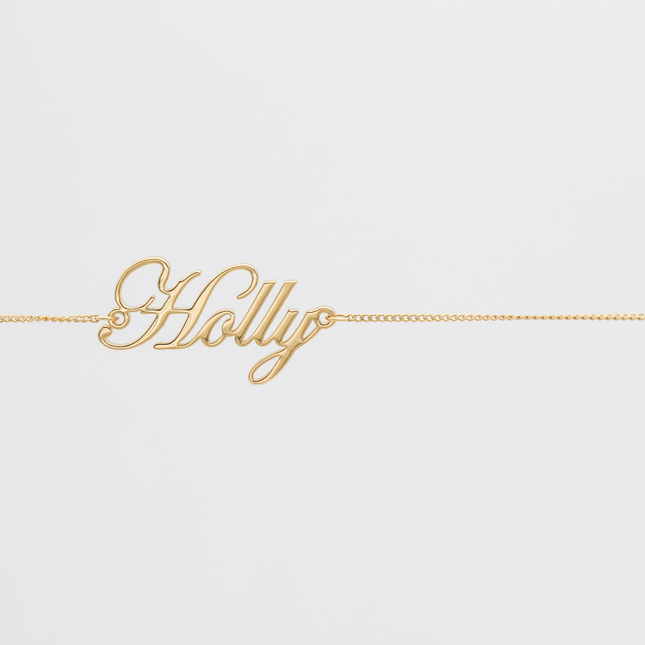 Gold belly chain with "Holly" name pendant.