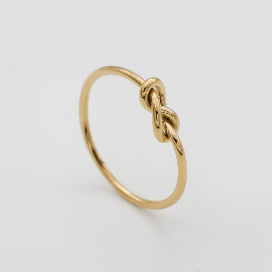 Gold ring with a delicate knot design.