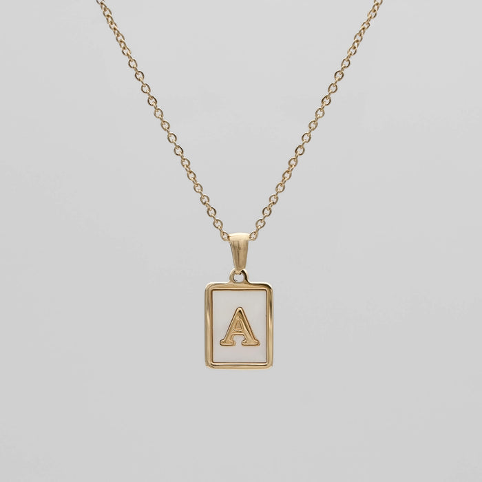 Gold opal necklace with a letter "A" pendant.
