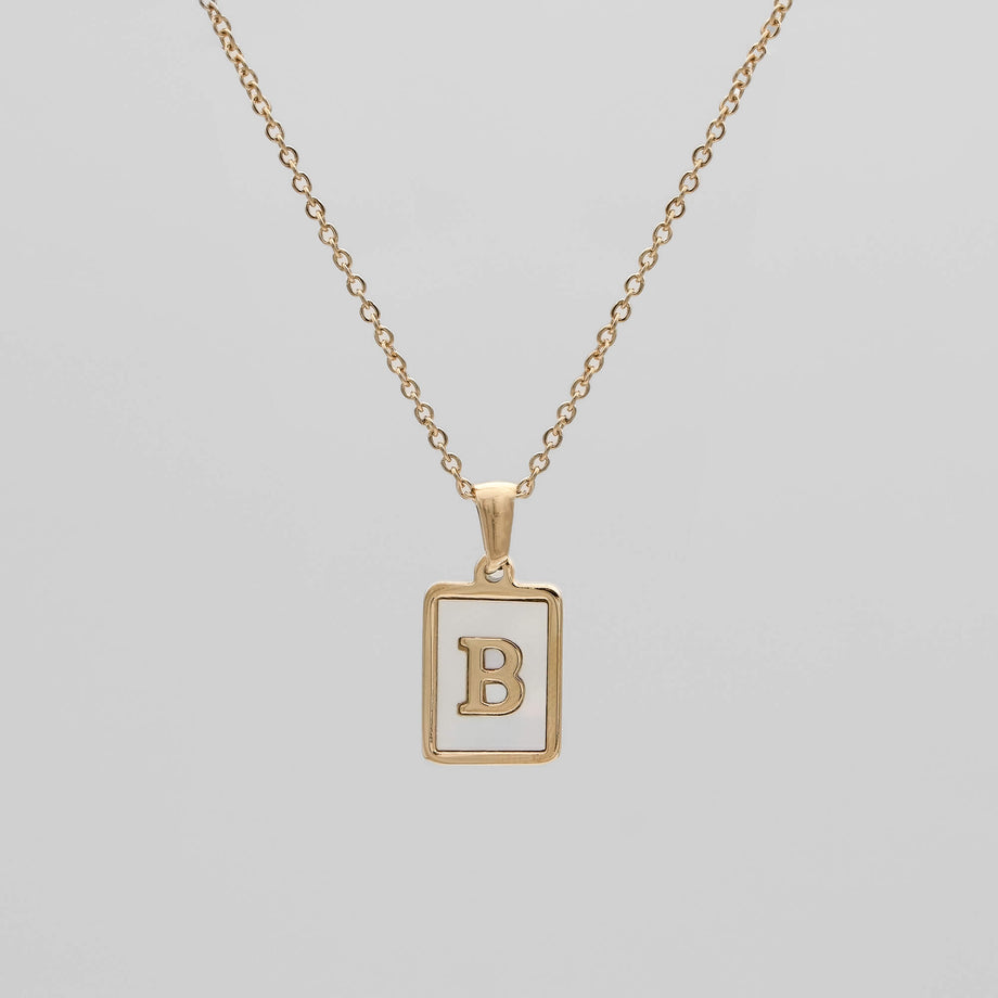 Gold opal necklace with a letter "B" pendant.