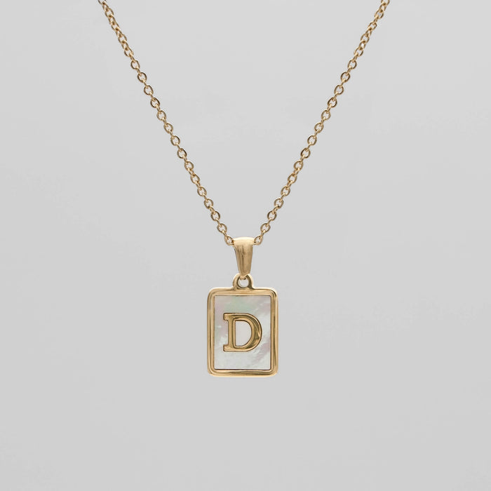 Gold opal necklace with a letter "D" pendant.