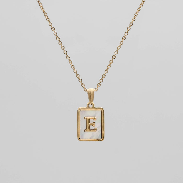 Gold opal necklace with a letter "E" pendant.