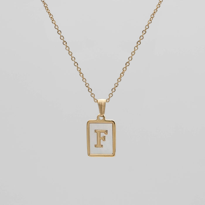 Gold opal necklace with a letter "F" pendant.
