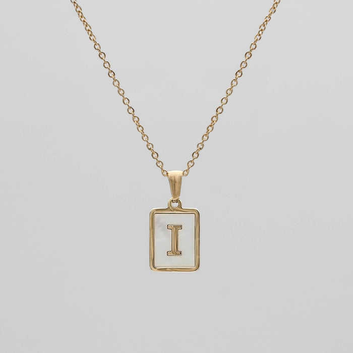 Gold opal necklace with a letter "I" pendant.