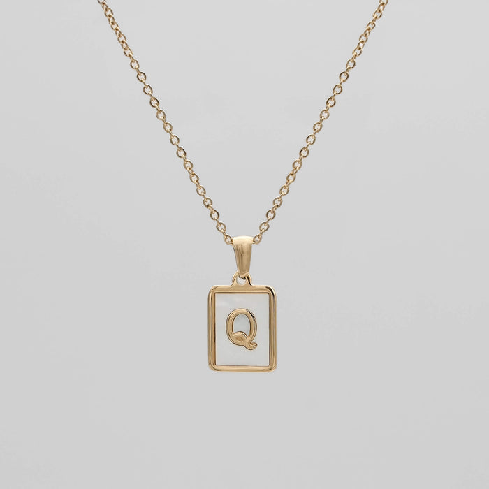 Gold opal necklace with a letter "Q" pendant.