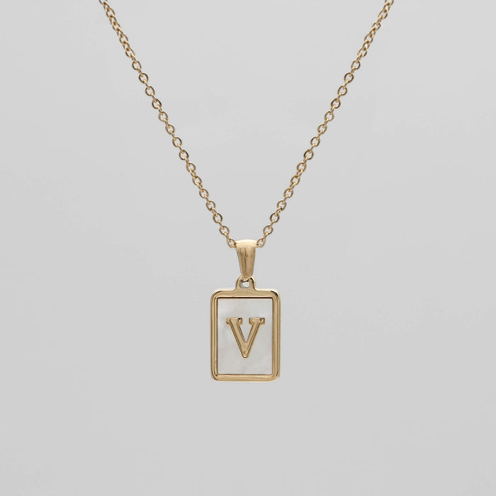Gold opal necklace with a letter "V" pendant.