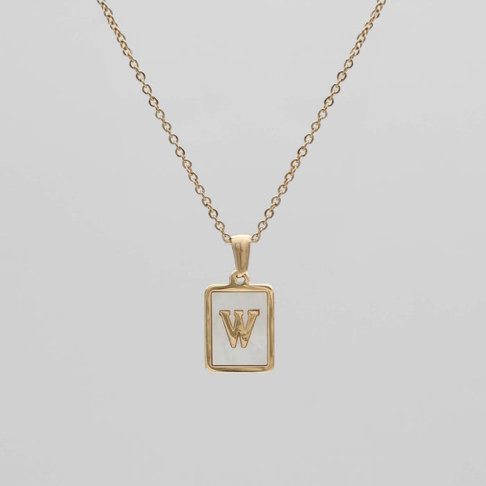 Gold opal necklace with a letter "W" pendant.