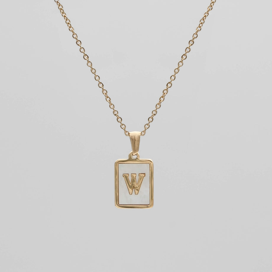 Gold opal necklace with a letter "W" pendant.