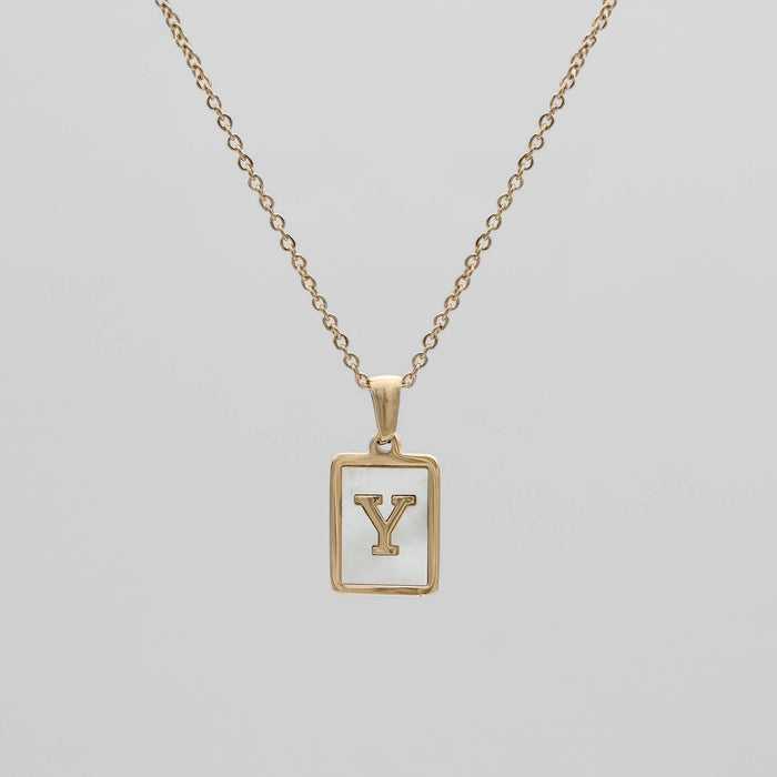 Gold opal necklace with a letter "Y" pendant.