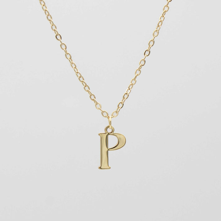 Gold plated initial necklace featuring the letter "P" on a delicate chain, perfect for personalization.