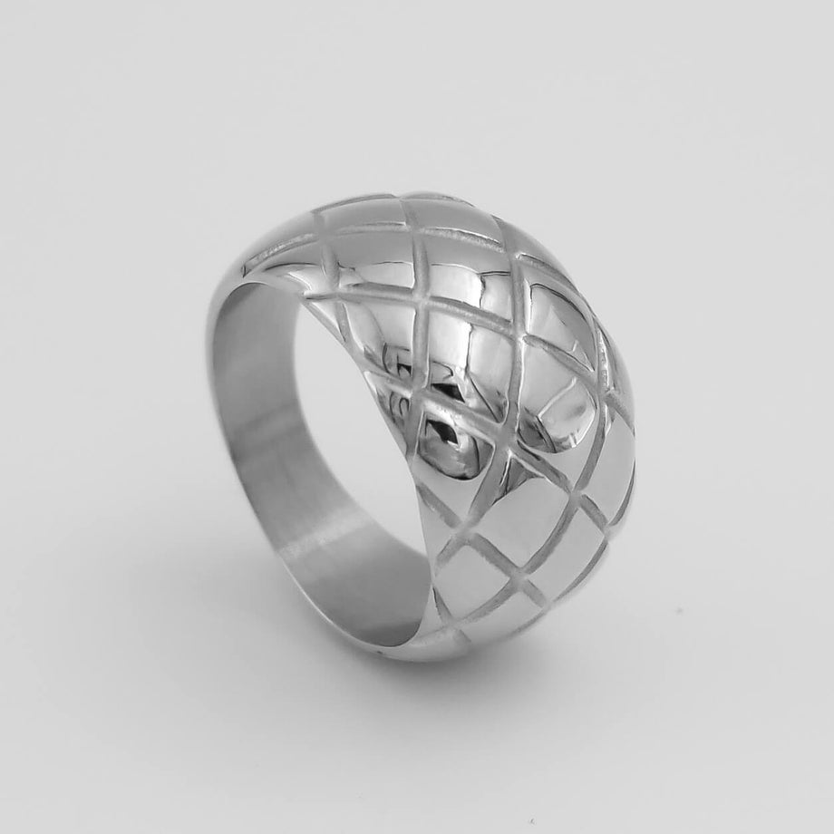 Silver ring with quilted pattern design.