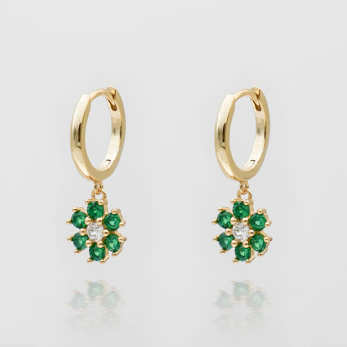 Gold hoop earrings with green flower charms.