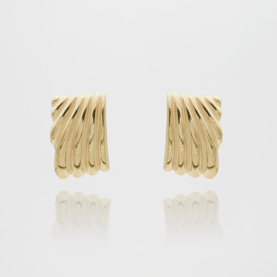 Gold textured hoop earrings on white background.