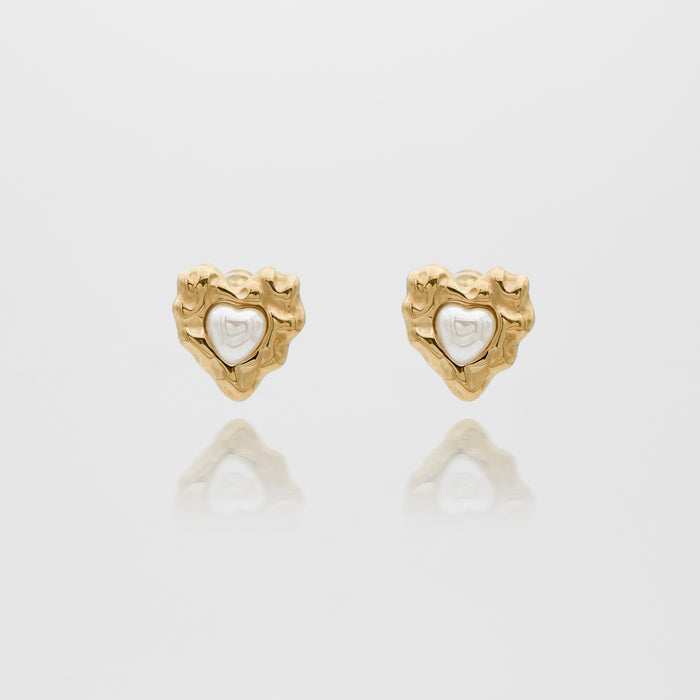 Gold heart-shaped earrings with white center.