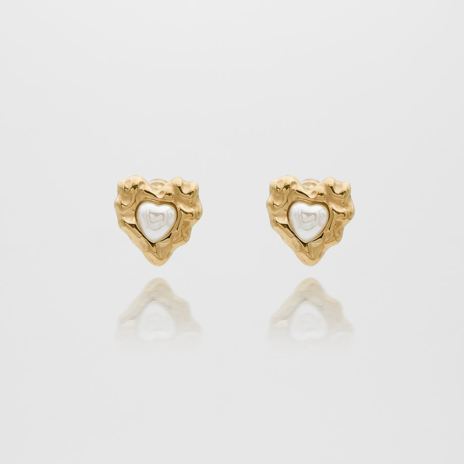 Gold heart-shaped earrings with white center.