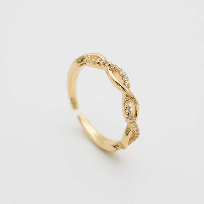 Gold twisted ring with small embedded stones.