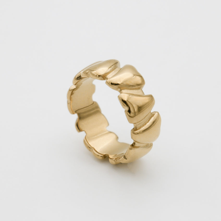 Gold ring with a wavy, sculpted design.