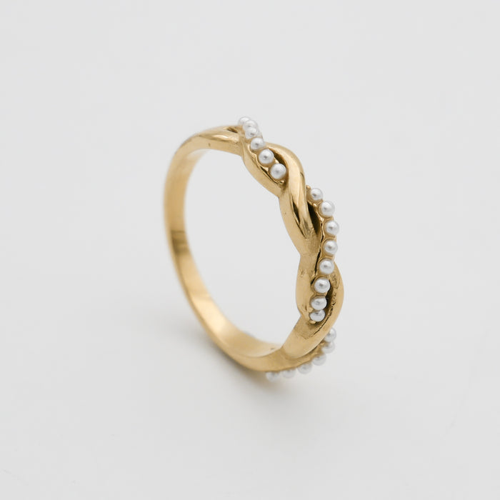 Gold ring with twisted pearl accents.