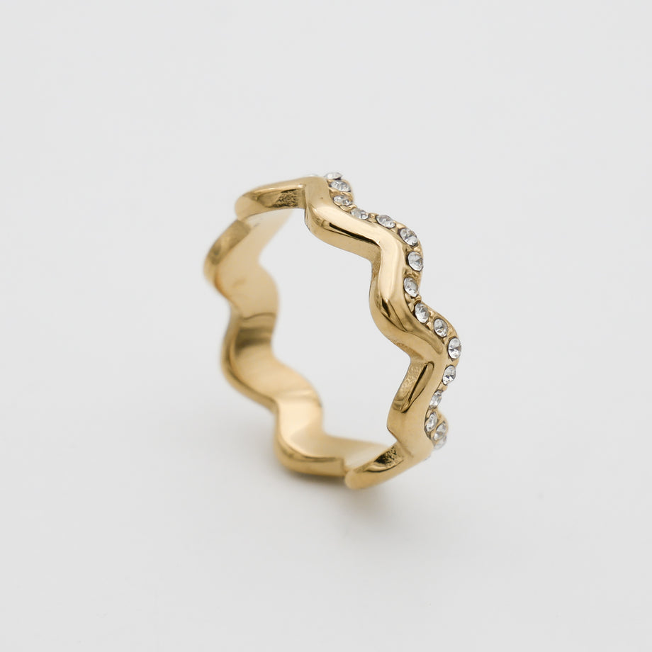 Gold zigzag ring with small gemstones.