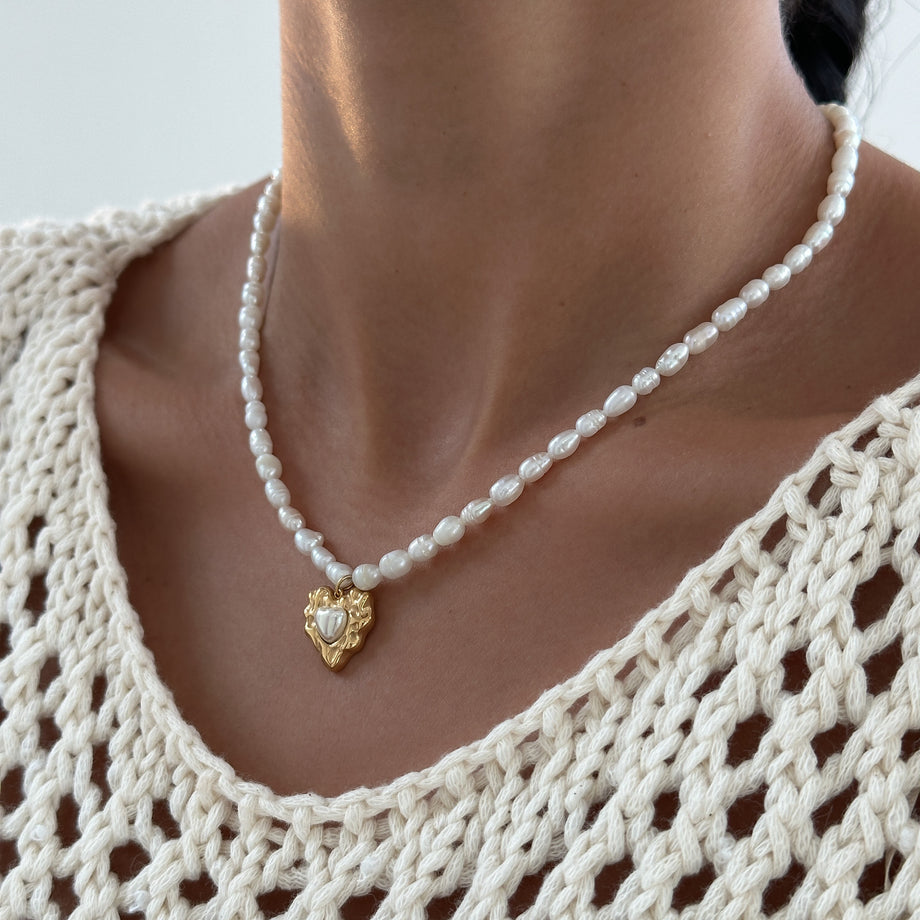 model wearing Pearl heart pendant necklace with 18k plated gold heart pendant from prya