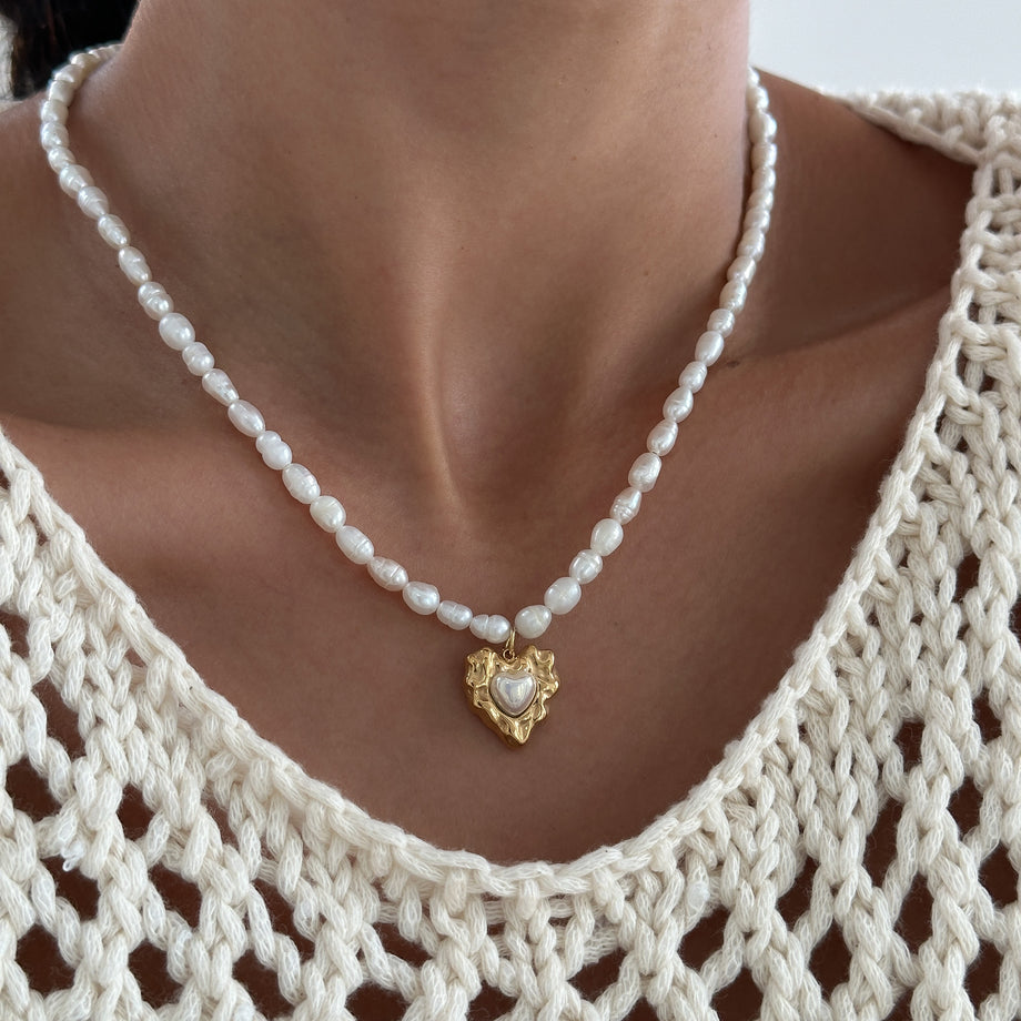 model wearing Pearl heart pendant necklace with 18k plated gold heart pendant from prya