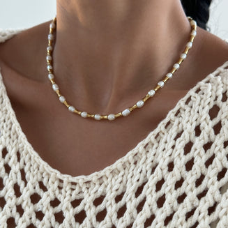 model wearing The Eden Pearl Bead Necklace, features delicate gold plated bamboo shaped beads and lustrous pearls from PRYA