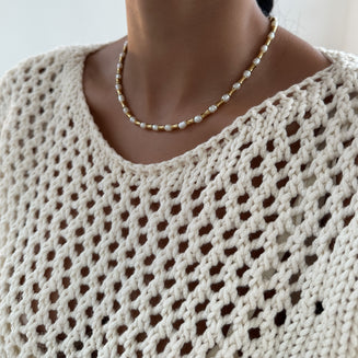 model wearing The Eden Pearl Bead Necklace, features delicate gold plated bamboo shaped beads and lustrous pearls from PRYA