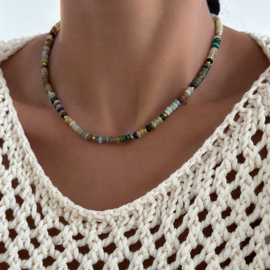  model wearing Ren Natural Stone Beaded Necklace, in earthy or water tones, accented by lustrous gold plated beads. 