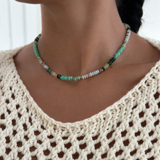  model wearing Ren Natural Stone Beaded Necklace, in earthy or water tones, accented by lustrous gold plated beads. 