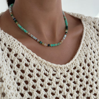  model wearing Ren Natural Stone Beaded Necklace, in earthy or water tones, accented by lustrous gold plated beads. 