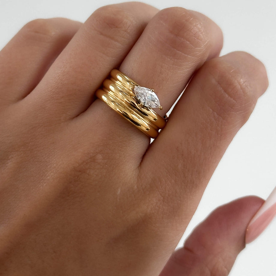 model wearing Emilia Ring is a bold, chunky gold plated ring inspired by retro style. Featuring a dazzling CZ centre stone from prya