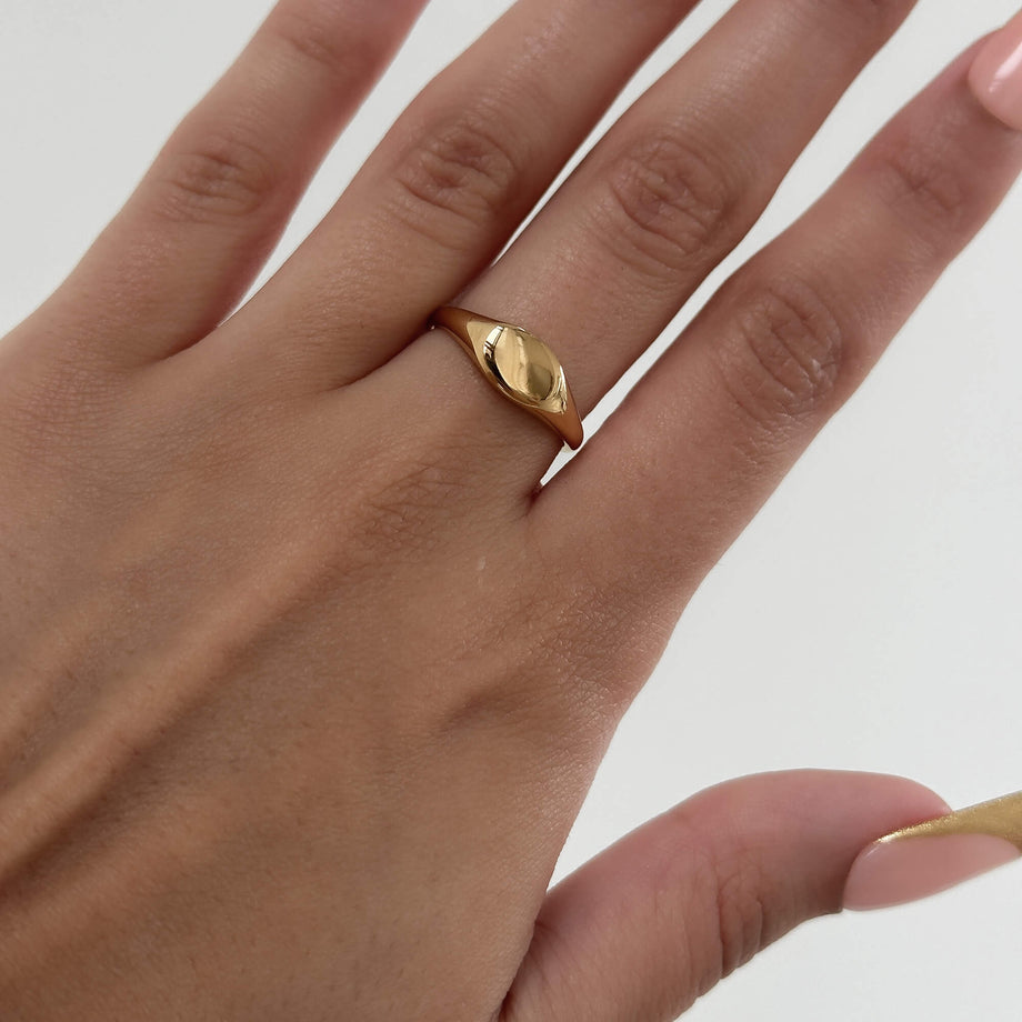 model wearing Kiara Ring iconic Gold plated Signet ring with an oval shape from Prya