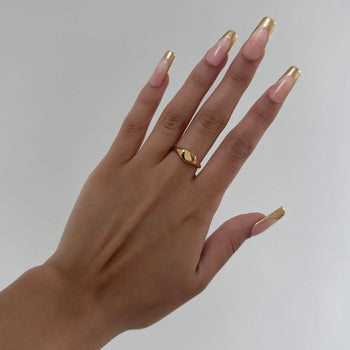 model wearing Kiara Ring iconic Gold plated Signet ring with an oval shape from Prya