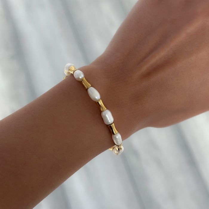 model wearing The Eden Pearl Bead bracelet, features delicate gold plated bamboo shaped beads and lustrous pearls from PRYA