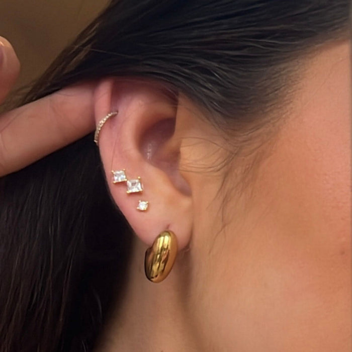 model wearing  stack of earrings including luna set from prya