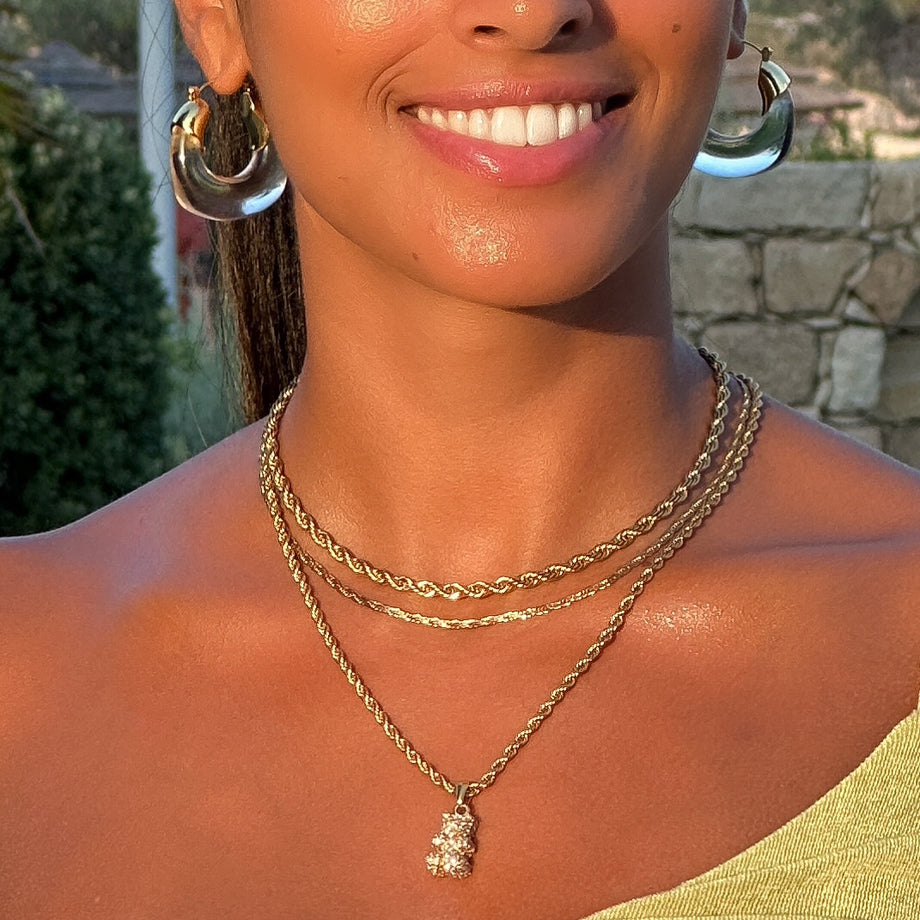 Model wearing Clear Celine lucite hoop with an oval shape