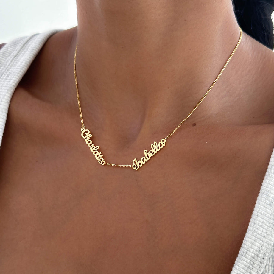 model wearing multiple Miami name necklace in gold from prya