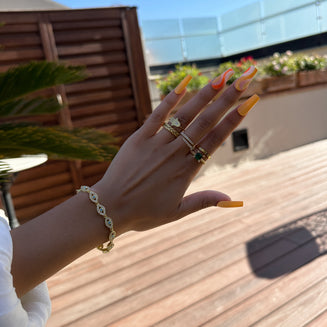 Model wearing Gold Evil eye bracelet  paved with CZ stones