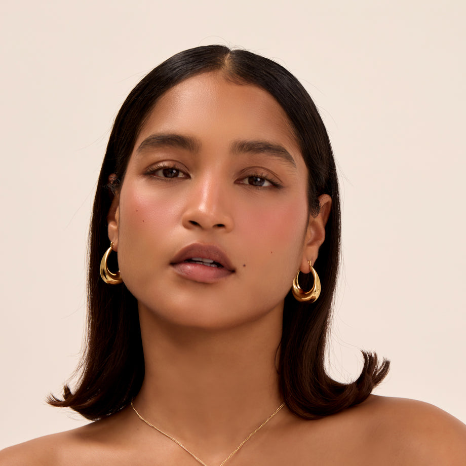 model wearing alyssa chunky gold hoop earrings from prya