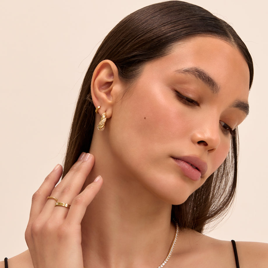 model wearing gia twisted hoop earrings in pave gold from prya