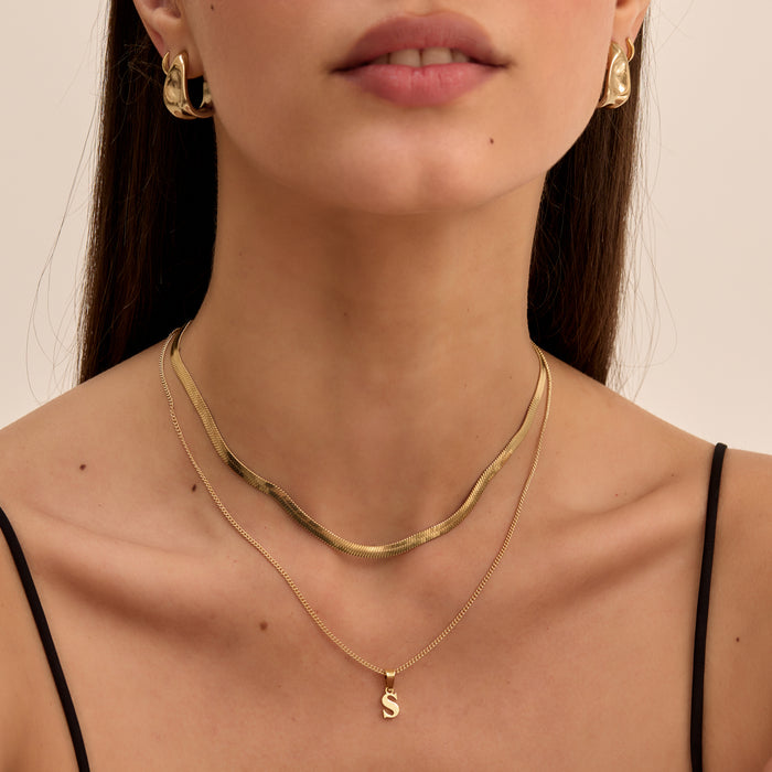 model wearing personalised  kayla lowercase initial necklace and herringbone gold necklace from prya