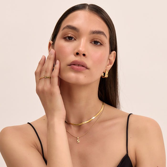 model wearing personalised  kayla lowercase initial necklace and herringbone gold necklace from prya