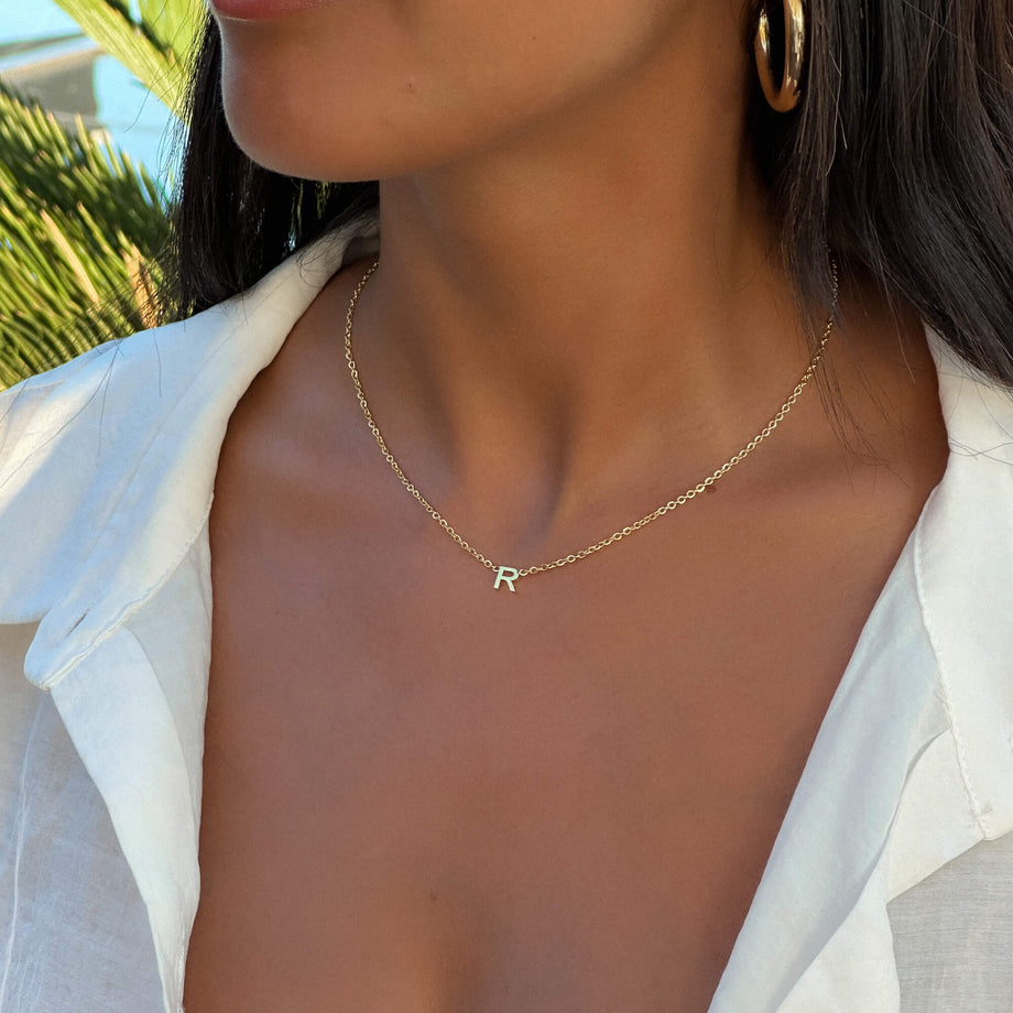 Model wearing Mini initial necklace in gold