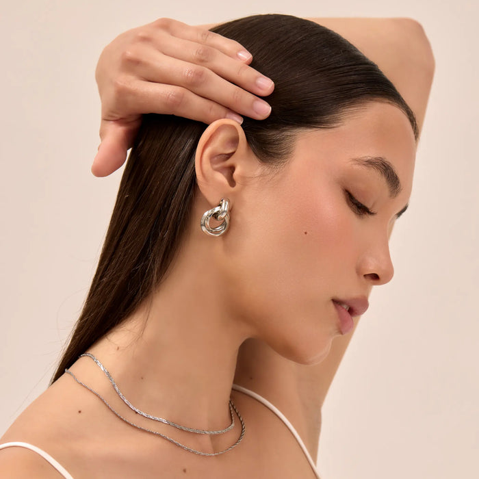 model wearing nadia knot knocker earring in silver from pryav