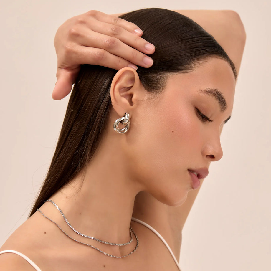 model wearing nadia knot knocker earring in silver from pryav