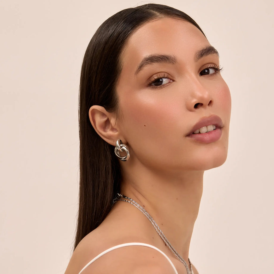 model wearing nadia knot knocker earring in silver from prya