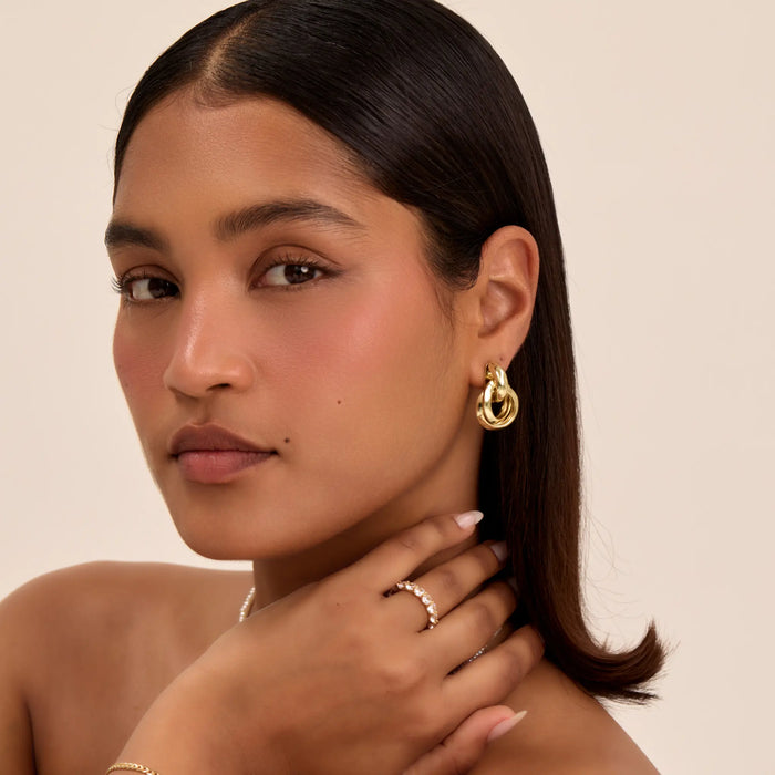 model wearing nadia knot knocker earring in gold from prya