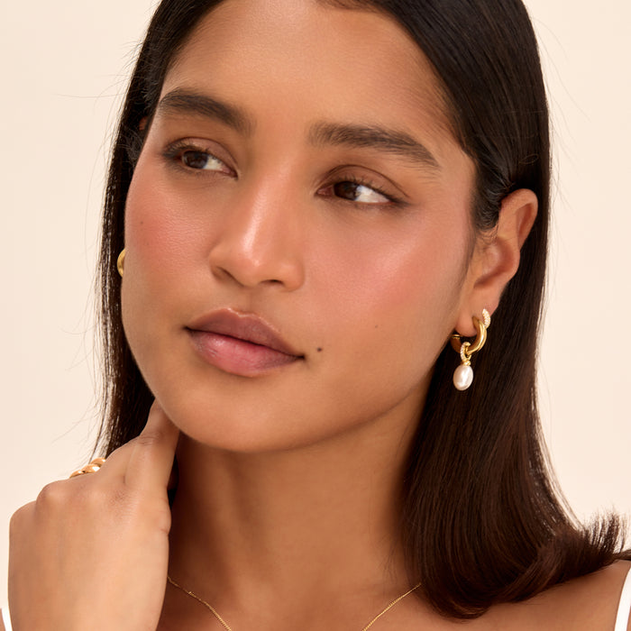 model wearing pave nala pearl earrings in gold from prya