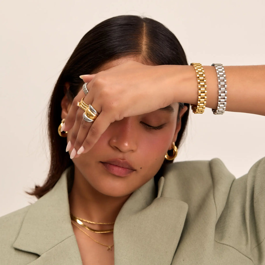 Model wearing gold  and silver watch strap bracelet and mixed metal rings from prya
