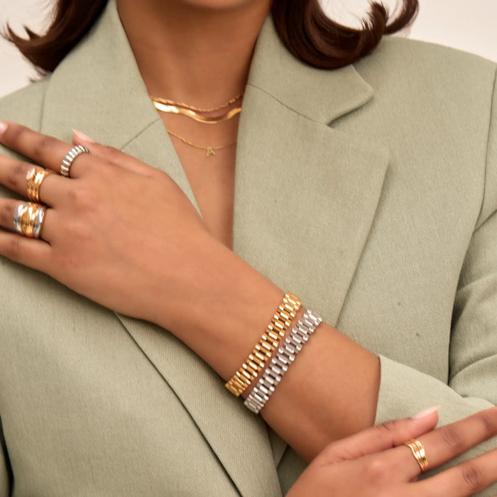 Model wearing gold and silver watch strap bracelet and mixed metal rings from prya
